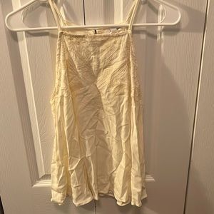 off white halter top with gold embellishments at top